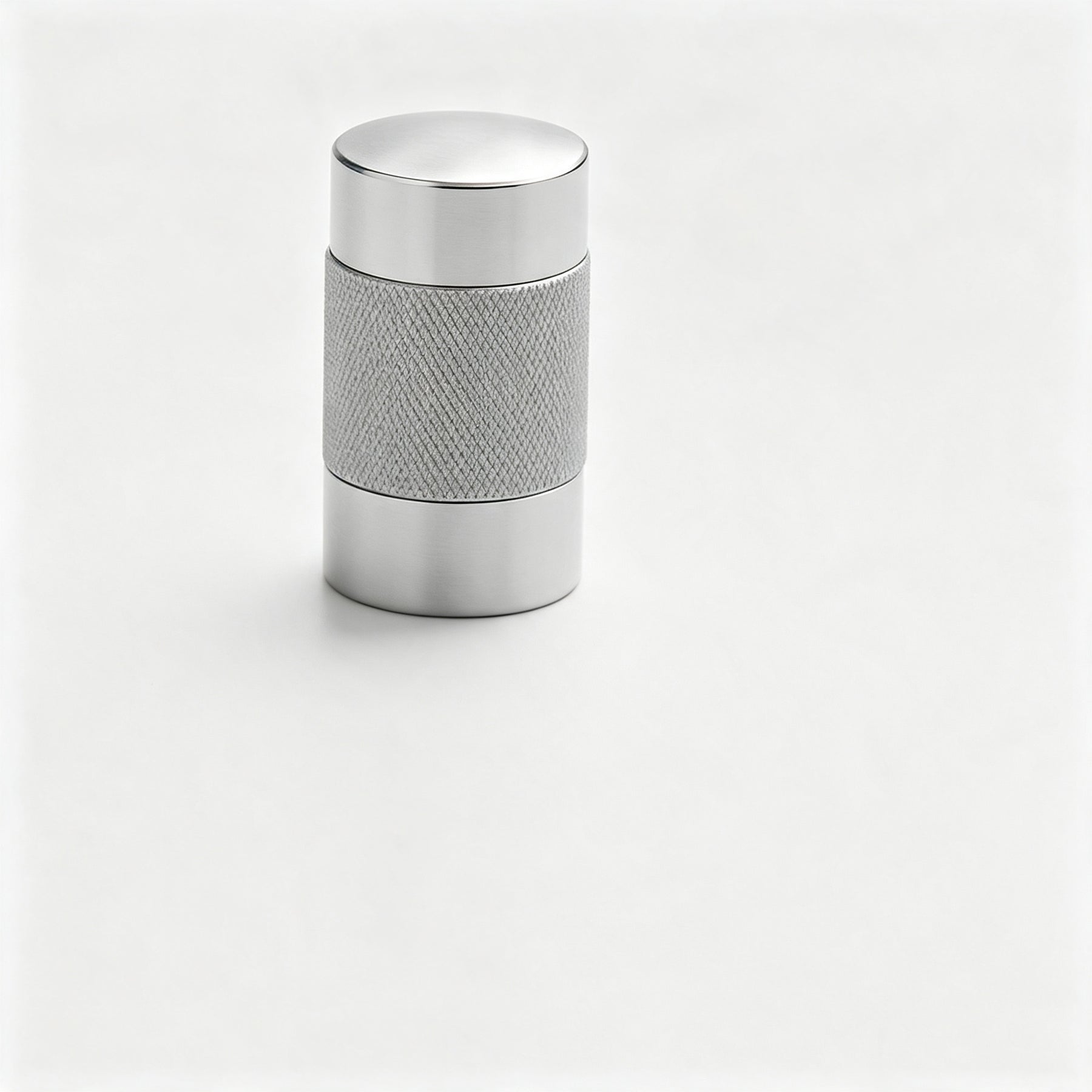 Silver-tone textured cylindrical cabinet knob on a white background