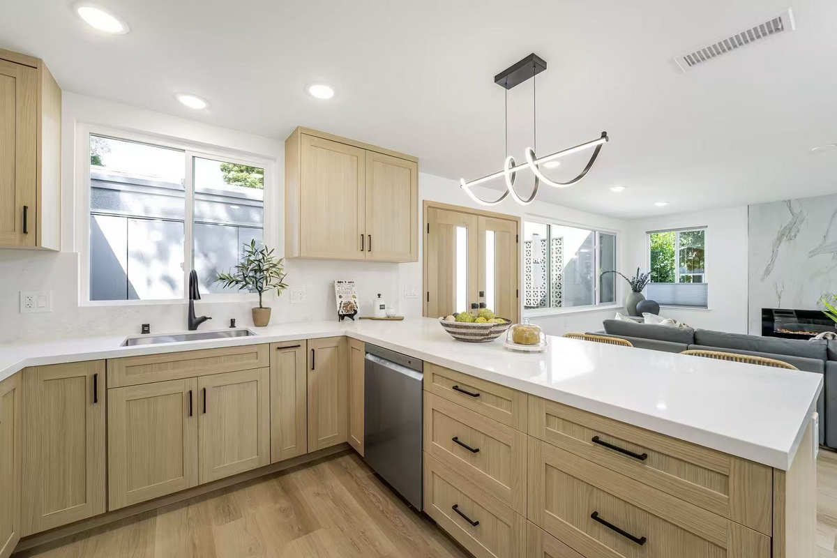 Light wood kitchen cabinets with white countertops
