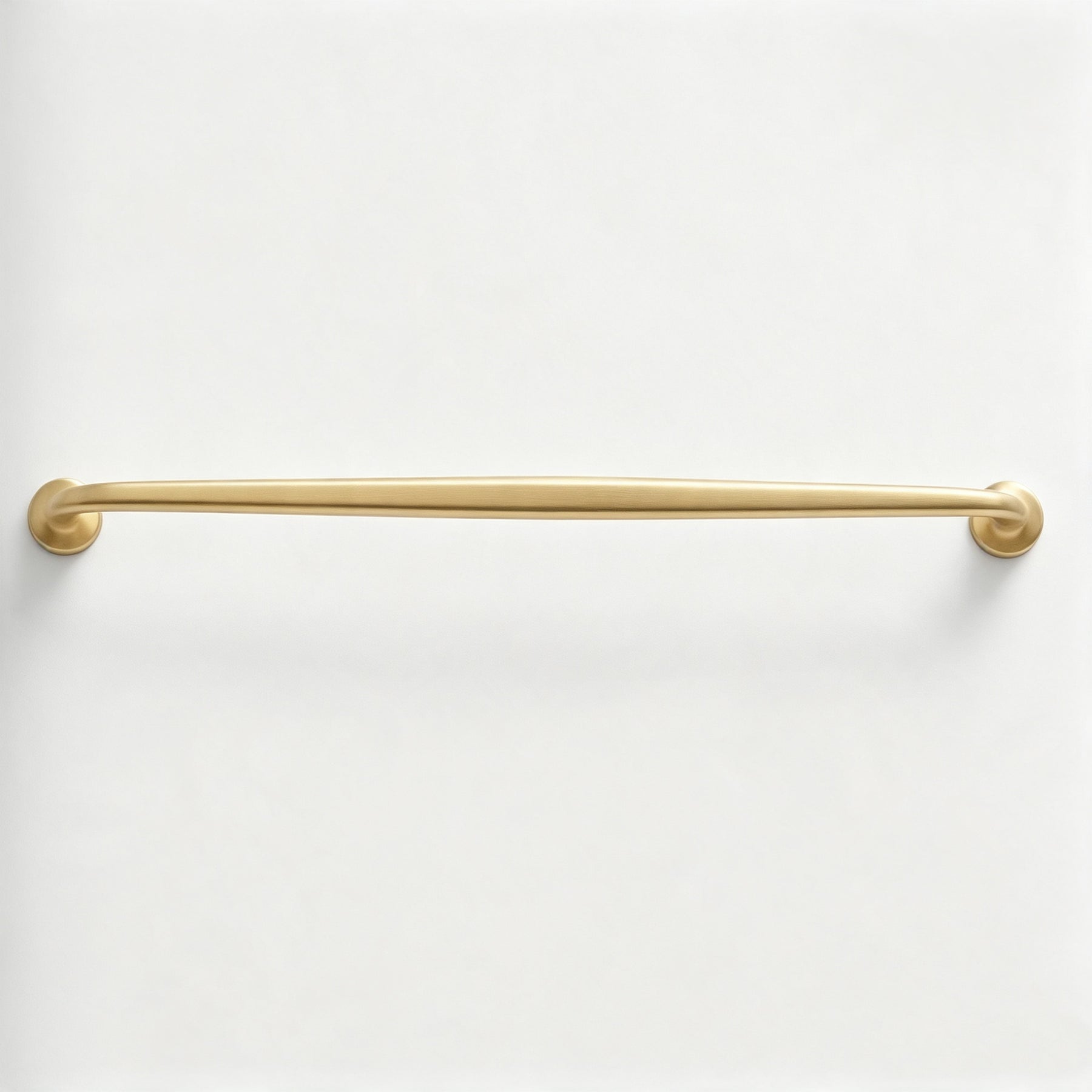 Slim warm metallic rail cabinet pull on a white background