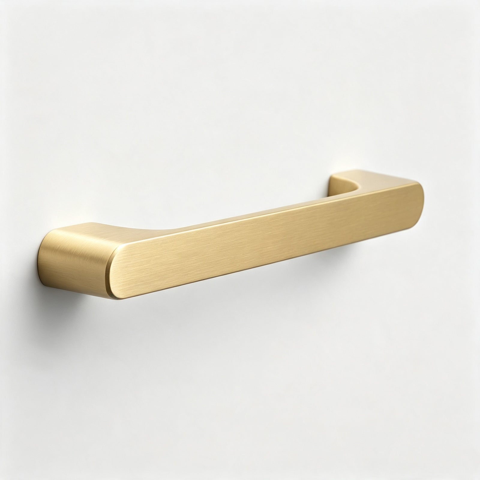 Slim warm metallic cabinet pull on a white background