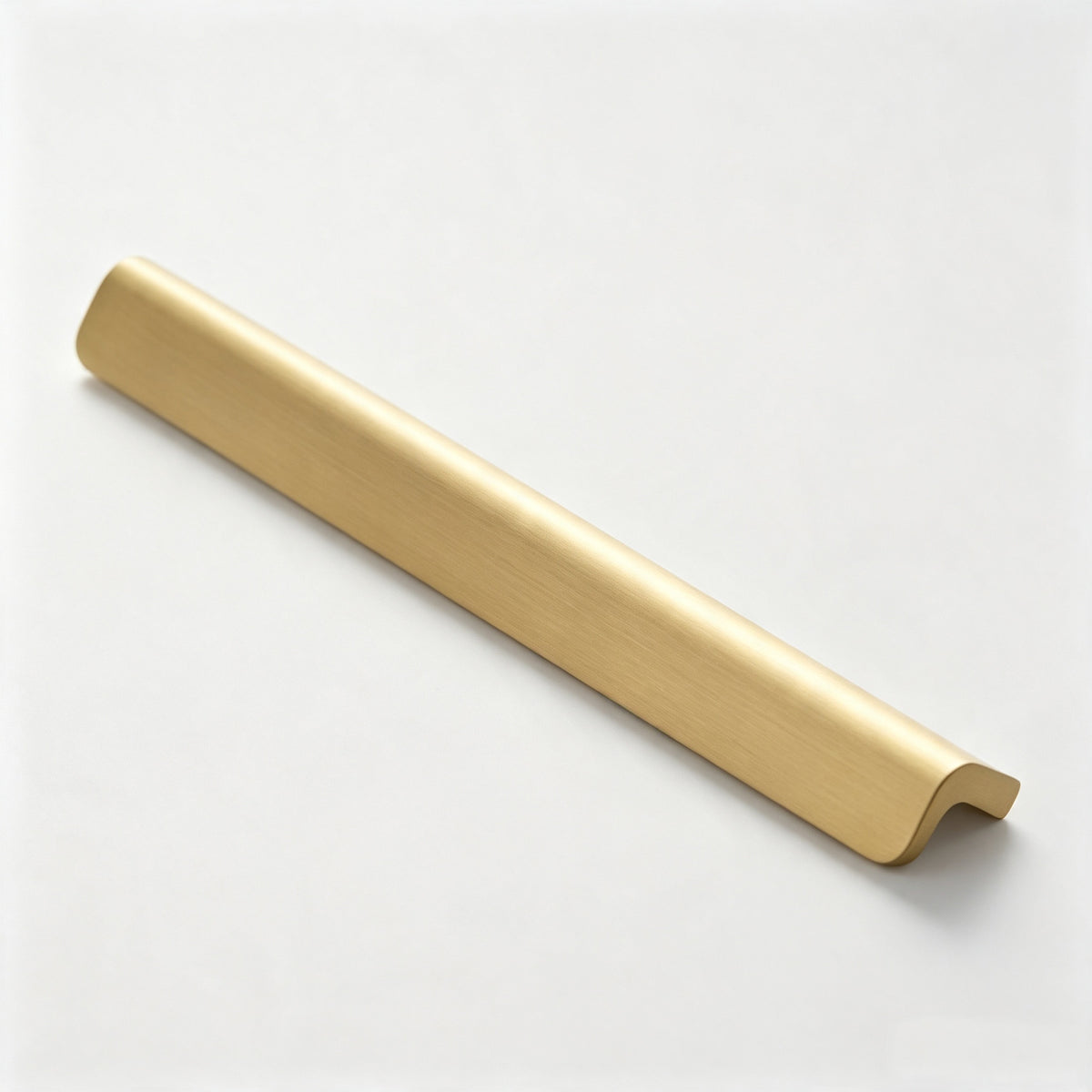 Warm metallic edge profile cabinet handle on a white background